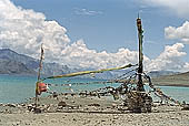 Ladakh - pile of stones on  mountain pass with the characteristc prayer flags